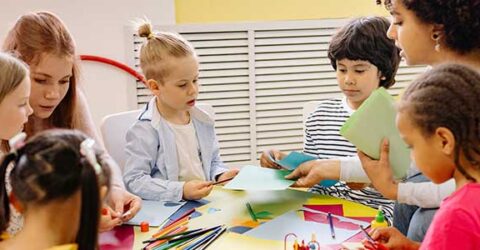 Art session round table with group of children and two adults